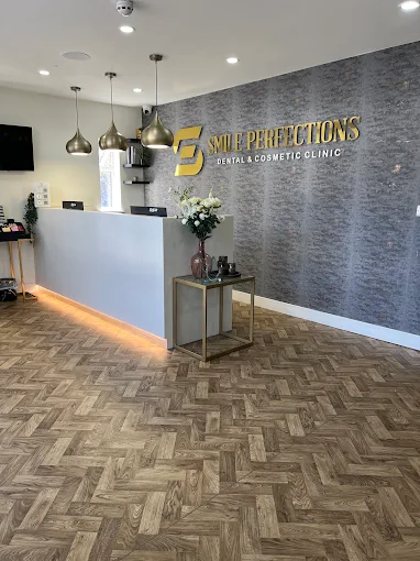 The Smile Perfections reception area, with the clinic name on the wall